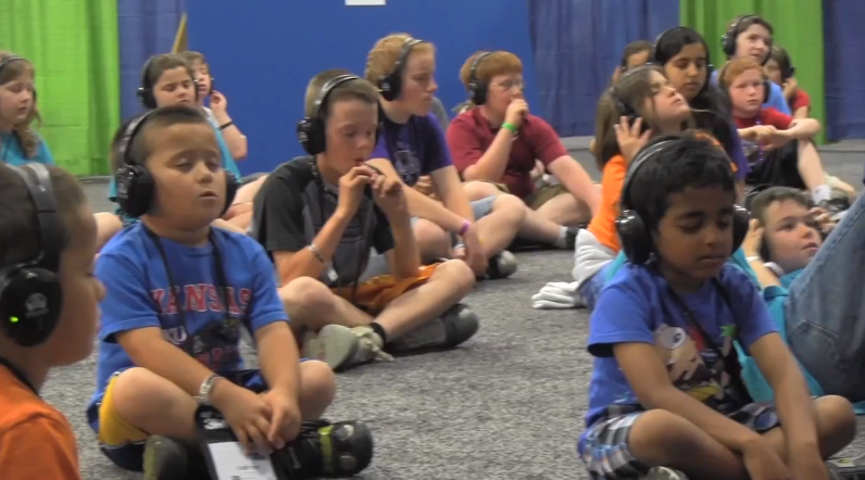 Kids harnessing their brain power through the Silent Storm Sound System "brain scanner".